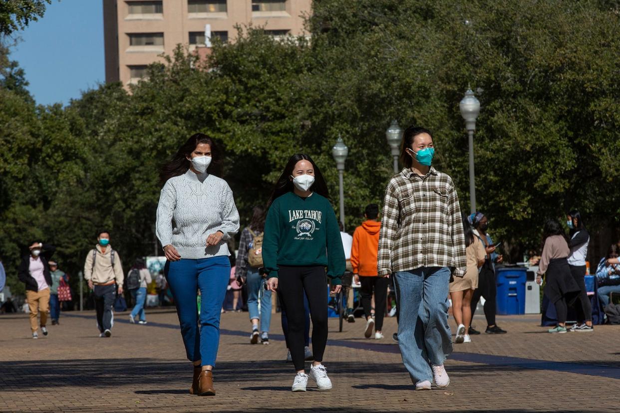 Richa Tiwary, Vivian Nguyen and Xin Fang walking on campus at The University of Texas at Austin in January. Rates of COVID-19 are not as high as when the omicron surge was happening in January, but they are climbing, sending Travis County into the medium level for transmission level instead of low, where we've been all spring.