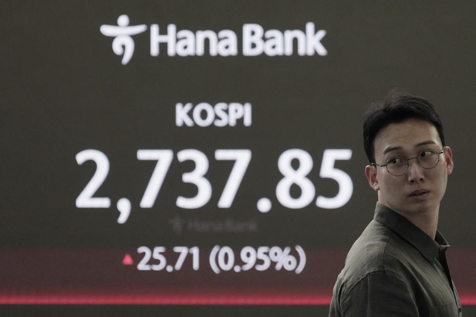 A currency trader works near the screen showing the Korea Composite Stock Price Index (KOSPI) at the foreign exchange dealing room of the KEB Hana Bank headquarters in Seoul, South Korea, Friday, May 10, 2024. (AP Photo/Ahn Young-joon)