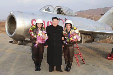 North Korean leader Kim Jong Un poses for pictures with female pilots as he provides field guidance to the flight drill of female pilots of pursuit planes of the KPA Air and Anti-Air Force in this undated photo released by North Korea's Korean Central News Agency (KCNA) in Pyongyang November 28, 2014. REUTERS/KCNA