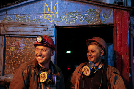 Miners smile while they speak with Reuters after the end of their shift at the Novovolynska-9 coal mine in Novovolynsk, Ukraine August 2, 2018. Picture taken August 2, 2018. REUTERS/Valentyn Ogirenko