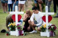 <p>People visit a cross for Christopher Stone at a memorial for the victims of the Santa Fe High School shooting on May 21, 2018 in Santa Fe, Texas. (Photo: Brendan Smialowski/AFP/Getty Images) </p>