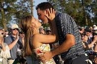 Scottie Scheffler kisses his wife after winning the 86th Masters golf tournament on Sunday, April 10, 2022, in Augusta, Ga. (AP Photo/David J. Phillip)