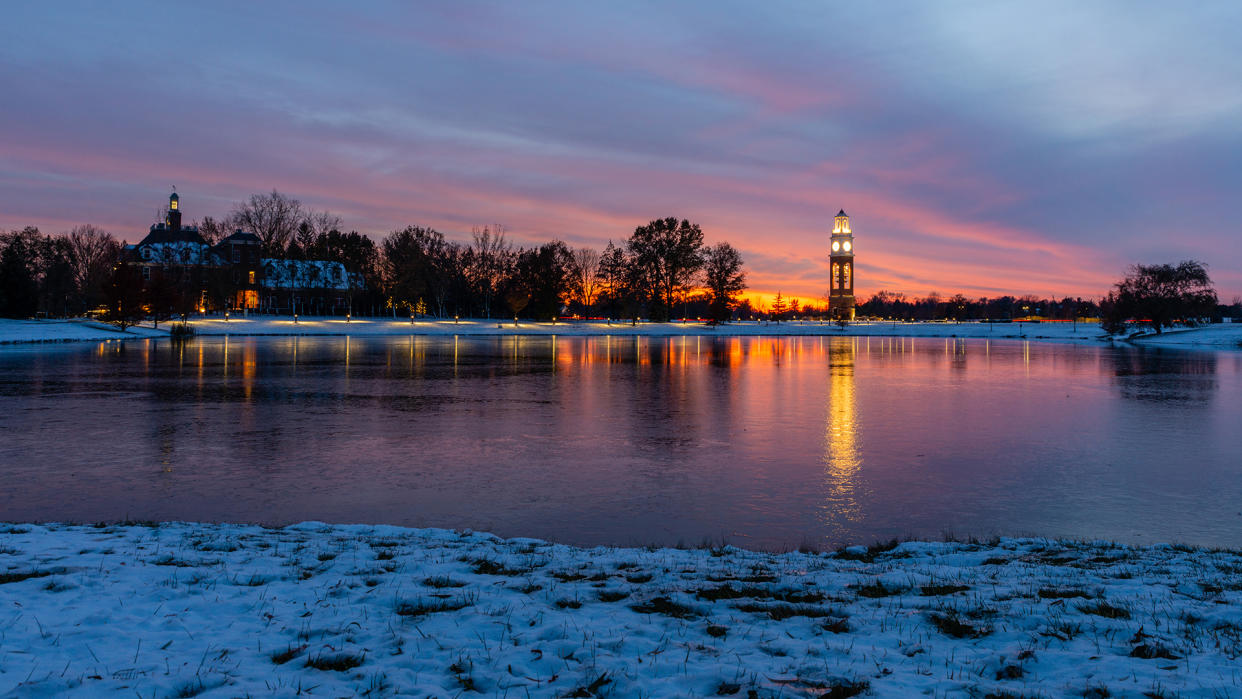 Bell tower and lake at Coxhall Garden in Carmel Indiana at sunset after snow in the winter of 2019 - Image.