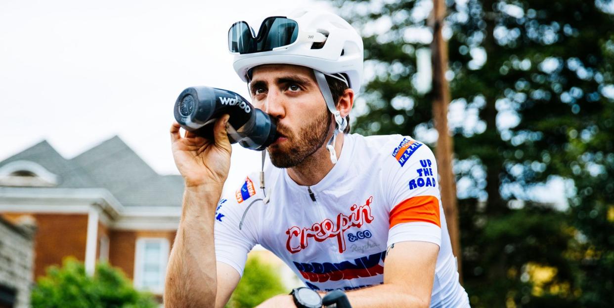 trevor raab sitting on his bike drinking from a water bottle