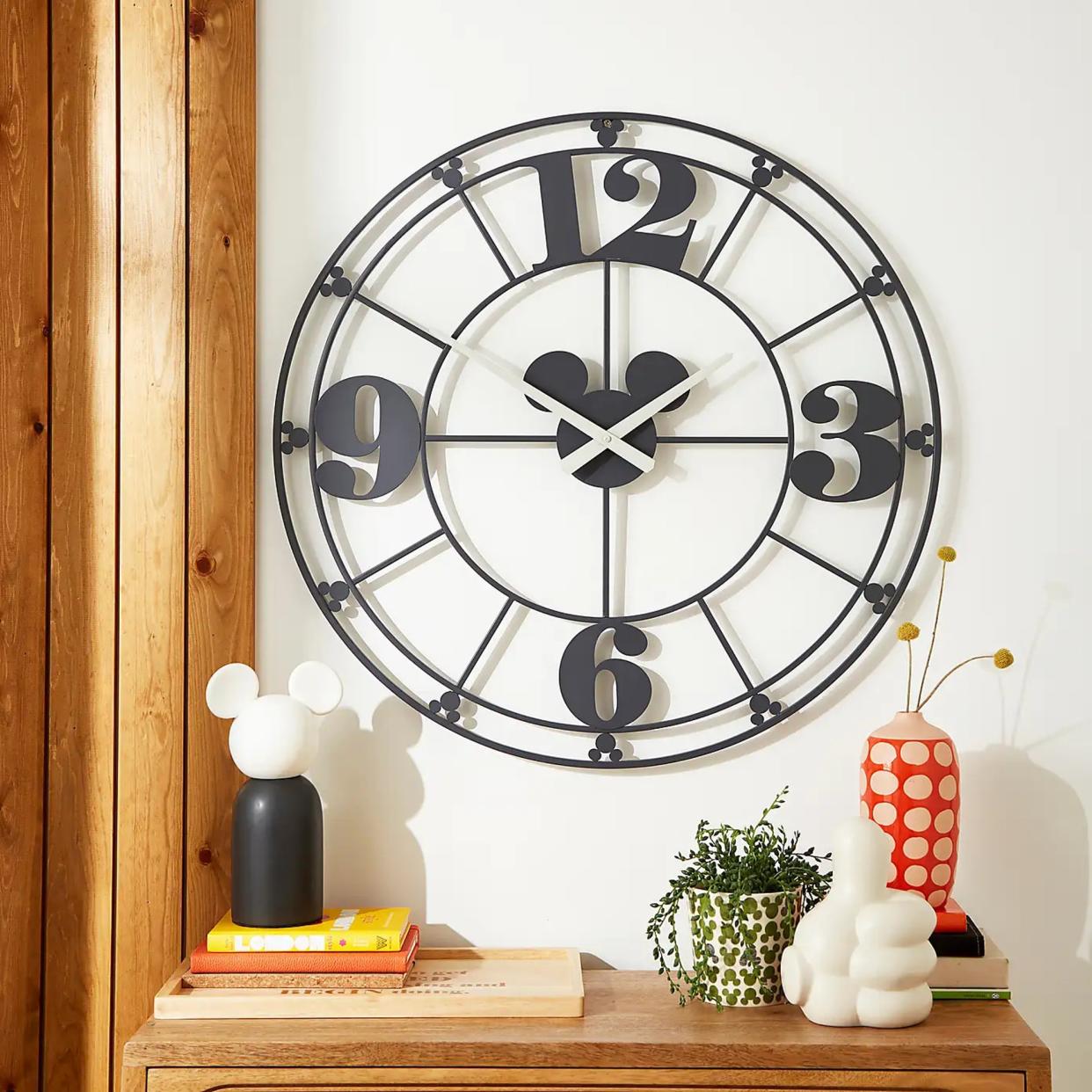  A hallway with a Mickey Mouse-themed clock and decorations 