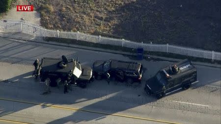 Police armored cars close in on a suspect vehicle following a shooting incident in San Bernardino, California in this still image taken from video December 2, 2015. REUTERS/NBCLA.com/Handout via Reuters