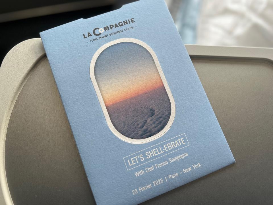 Flying on La Compagnie all-business class airline from Paris to New York — a brochure on La Compagnie's all-business class flight.