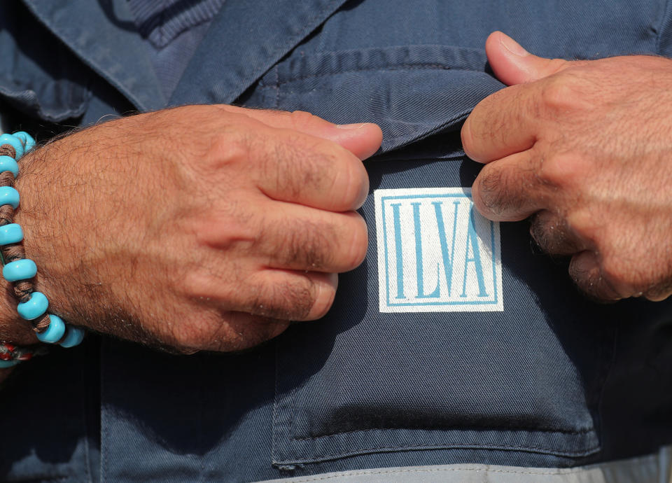 A worker adjusts his uniform outside ILVA's steel plant in Taranto, southern Italy, September 21, 2018. REUTERS/Alessandro Bianchi