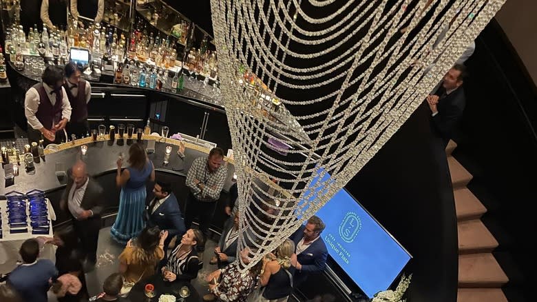 chandelier hangs from the ceiling above the bar