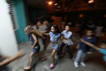 Children play while attending a birthday party celebration at Catia neighbourhood in Caracas, Venezuela, April 13, 2019. REUTERS/Ivan Alvarado