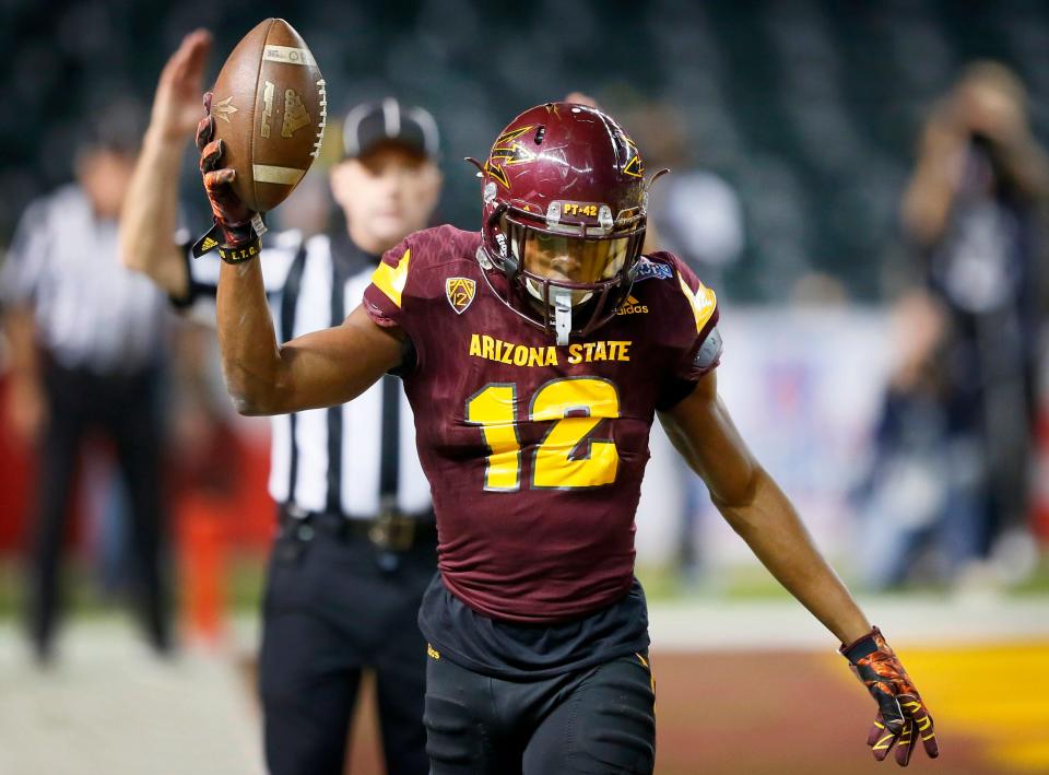 Arizona State wide receiver Tim White (12) signals touchdown after scoring during the second half of the Cactus Bowl NCAA college football game against West Virginia, Saturday, Jan. 2, 2016, in Phoenix. (AP Photo/Matt York)