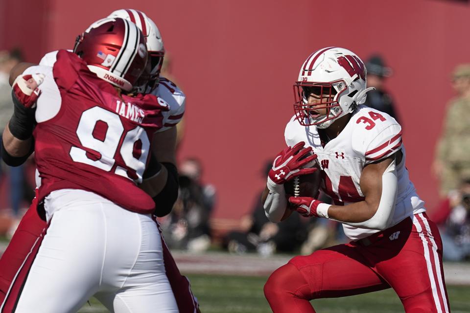 Wisconsin running back Jackson Acker (34) runs during the first half of an NCAA college football game against Indiana, Saturday, Nov. 4, 2023, in Bloomington, Ind. (AP Photo/Darron Cummings)
