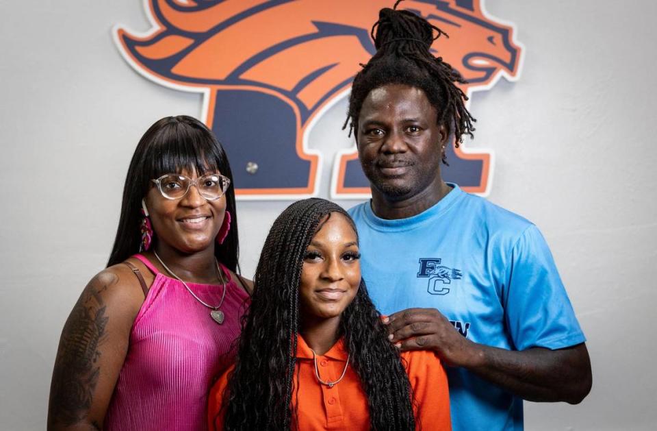 Homestead, Florida, August 28, 2023 - Janiya Baker, center, with her mother Jasmine Gary, left and her stepfather Travis Terry Sr., right, at Homestead High School.