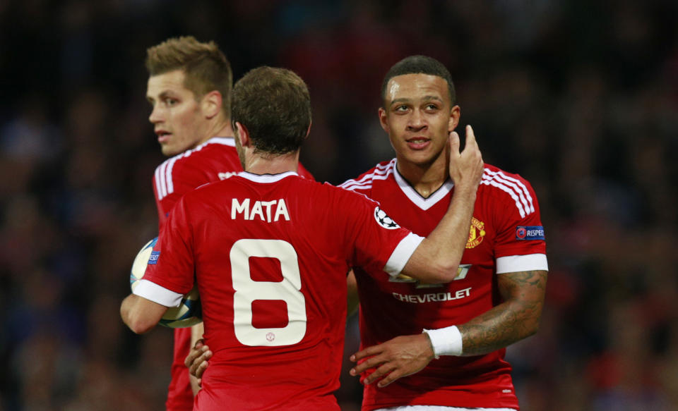 Memphis Depay celebrates with Juan Mata after scoring the second goal for Manchester United