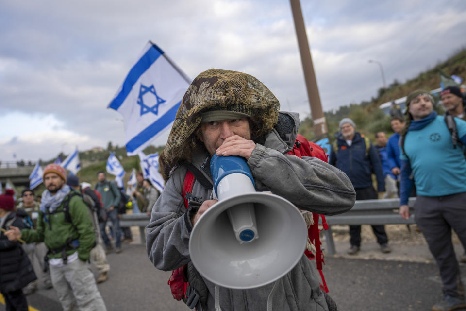 FILE - Israeli military reservists protest against the plans by Prime Minister Benjamin Netanyahu's new government to overhaul the judicial system, on a freeway from Tel Aviv to Jerusalem, Thursday, Feb. 9, 2023. A contentious judicial overhaul that is dividing Israel is tearing at the country's main unifying force: the military. Former top security officials are greenlighting insubordination in the face of what they say is impending regime change. And some reservists say they'll heed the call. (AP Photo/Ohad Zwigenberg, File)