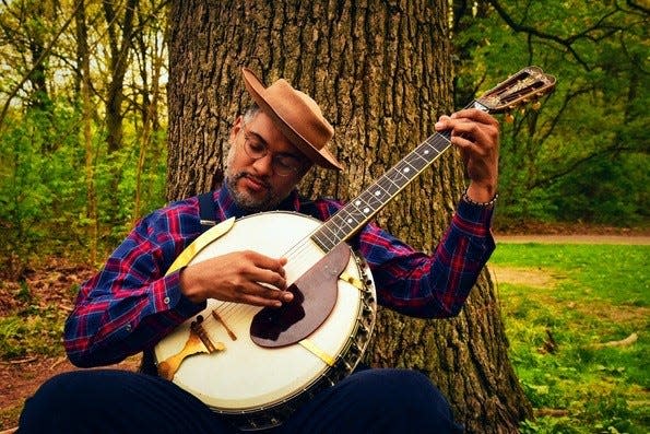 Multi-instrumentalist Dom Flemons plays his gourd banjo.