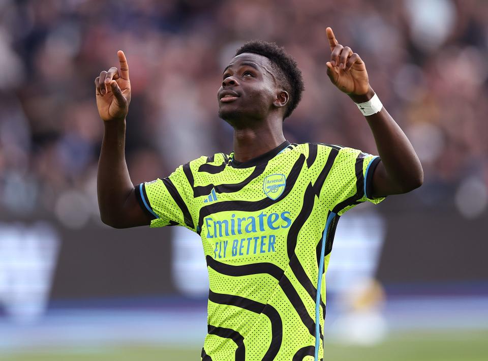 Bukayo Saka of Arsenal celebrates scoring his team's second goal from the penalty spot during the Premier League match between West Ham United and Arsenal. (Photo by Julian Finney/Getty Images)