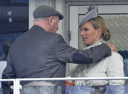 Britain's Zara Phillips (R) speaks with horse owner and businessman Trevor Hemmings at the Cheltenham Festival horse racing meet in Gloucestershire, western England March 14, 2014. REUTERS/Toby Melville