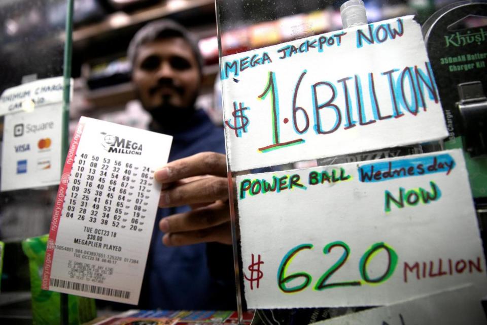 A newsstand vendor displays tickets for Tuesday's Mega Millions (REUTERS)