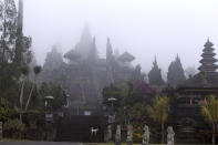 <p>Bali’s most prominent temples, called Pura Besakih and located a few kilometers away from the mountain’s slopes, are seen in the fog, Bali, Indonesia, Sept. 25, 2017. More than 35,000 people have fled a menacing volcano on the Indonesia tourist island of Bali, fearing will erupt for the first time in more than half a century as increasing tremors rattle the region. (AP Photo/Firdia Lisnawati) </p>