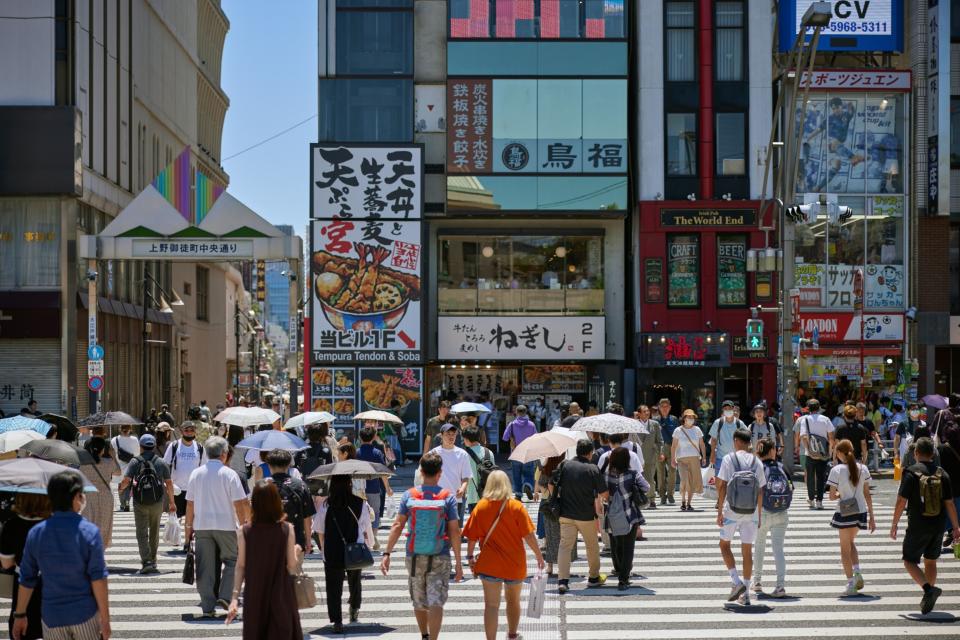 Pedestrians cross a street in Tokyo, Japan, on Sunday, July 30, 2023.  Photographer: Shoko Takayasu/Bloomberg