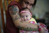 RNPS - PICTURES OF THE YEAR 2013 - Vanessa Moreno, 24, holds her two-month-old baby Makayla at Prototypes residential treatment program in Pomona, California, March 26, 2013. Prototypes is part of the Second Chance Women's Re-entry Court program, one of the first in the U.S. to focus on women. It offers a cost-saving alternative to prison for women who plead guilty to non-violent crimes and volunteer for treatment. Of the 297 women who have been through the court since 2007, 100 have graduated, and only 35 have been returned to state prison. REUTERS/Lucy Nicholson (UNITED STATES - Tags: SOCIETY CRIME LAW TPX)