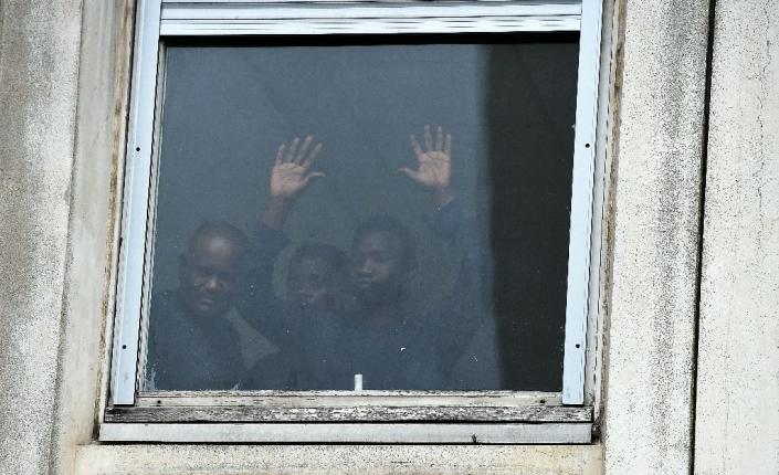 Refugees and migrants are seen at the former Jean-Quarre High School, turned into a shelter, on February 5, 2016, in Paris (AFP Photo/Alain Jocard )