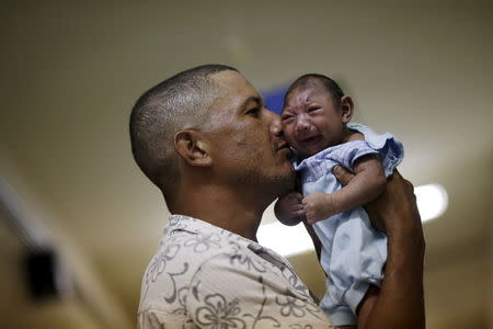 Geovane Silva holds his son Gustavo Henrique, who has microcephaly, at the Oswaldo Cruz Hospital in Recife, Brazil, January 26, 2016. REUTERS/Ueslei Marcelino