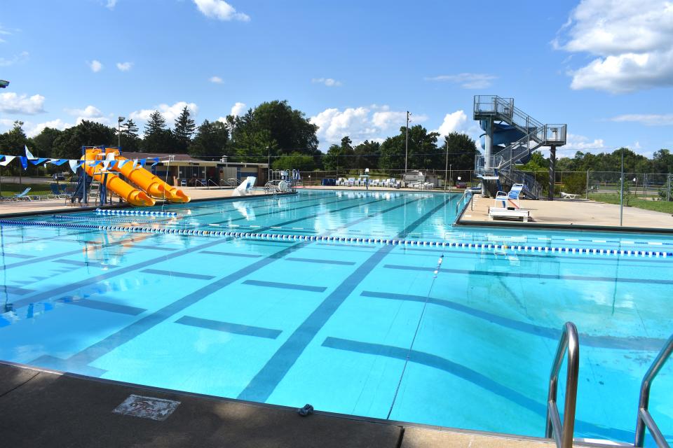 The swimming pool area at Adrian's Bohn Pool is pictured August 2021. Some features of the pool, constructed in 1972, include a child-friendly shallow end; 140-foot water slide; diving board; three tube drop slides; a basketball hoop for water basketball, and two lap lanes available during all open-swim times.