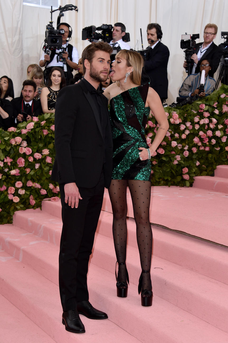 Miley licks Liam on the Met Gala red carpet. Photo: Getty