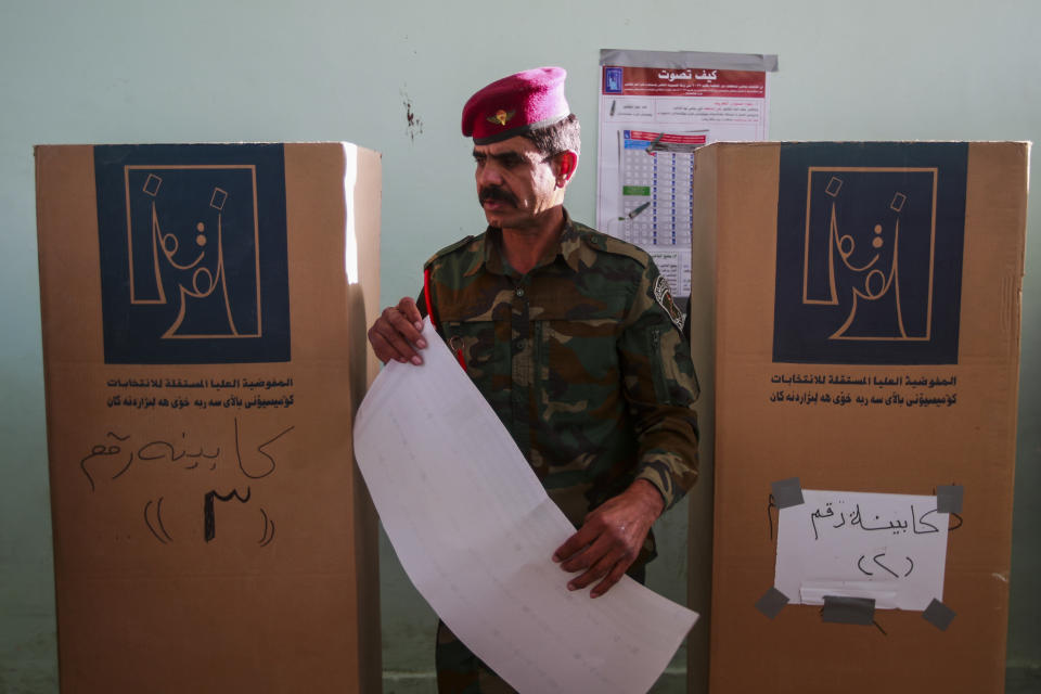 Iraqi security forces members participate in the provincial elections in Najaf, Iraq, Saturday, Dec. 16, 2023. (AP Photo/Anmar Khalil)