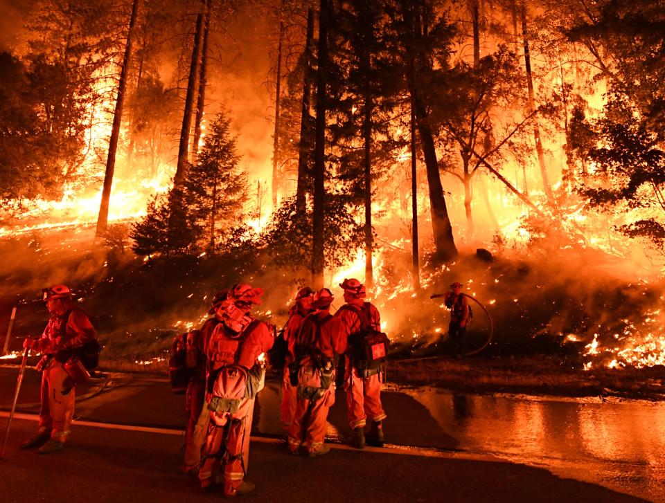 Firefighters try to control a back burn as the Carr Fire continues to spread toward the towns of Douglas City and Lewiston near Redding, Calif., on July 31. (Photo: Mark Ralston/AFP/Getty Images)