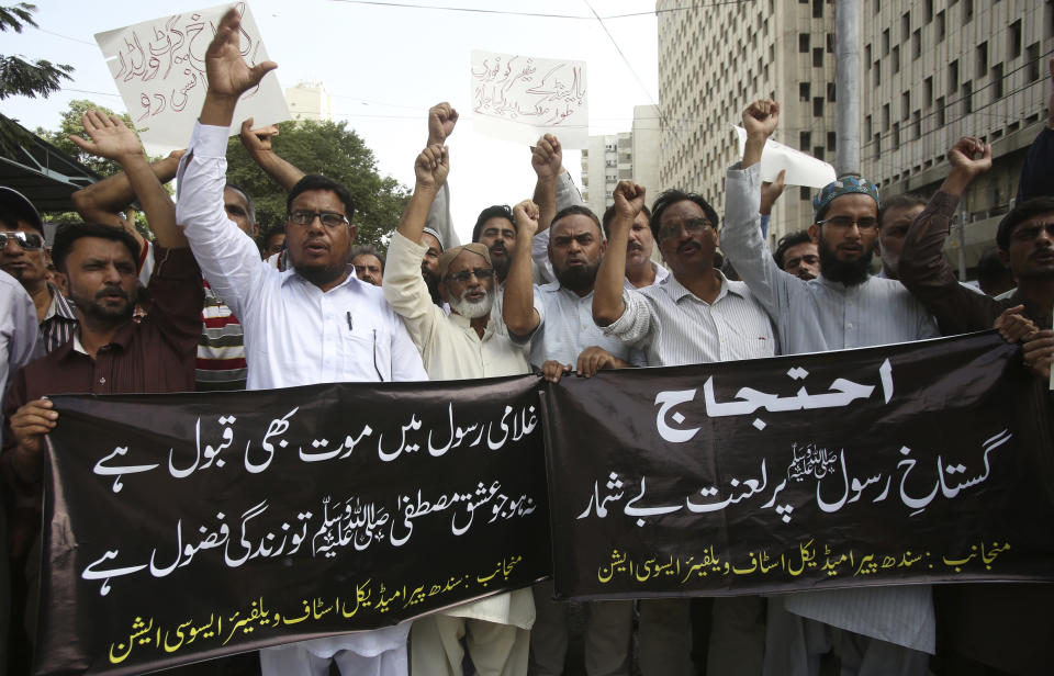 Pakistani protesters shout slogans during a protest against the planned anti-Islam cartoon competitions, in Karachi, Pakistan, Wednesday, Aug. 29, 2018. Thousands of Islamists in Pakistan launched a march in Lahore toward the capital on Wednesday to protest a far-right Dutch lawmaker's plans to hold a Prophet Muhammad cartoon contest later this year. (AP Photo/Fareed Khan)