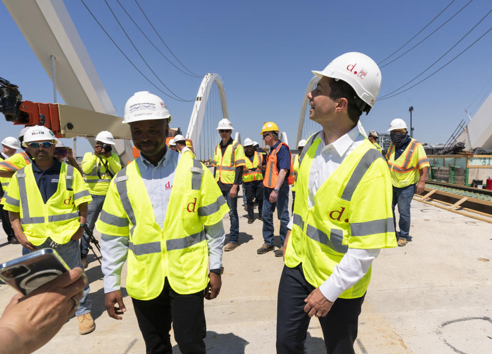 Secretary of Transportation Pete Buttigieg, right, visits the Frederick Douglass Memorial Bridge construction site together with District of Columbia Mayor Muriel Bowser and Secretary of Labor Marty Walsh, in southeast Washington, Wednesday, May 19, 2021. (AP Photo/Manuel Balce Ceneta)