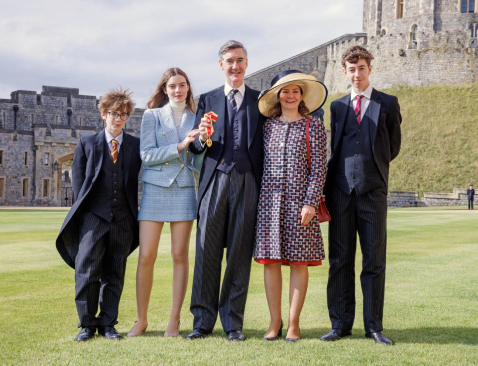 WINDSOR, ENGLAND - SEPTEMBER 27: Jacob Rees-Mogg, formerly Minister of State for Brexit Opportunities and Government Efficiency, poses with his family, wife Helena, children Mary, Thomas (L) and Peter as he receives his Knighthood at Windsor Castle on September 27, 2023 in Windsor, England. (Photo by Jonathan Buckmaster - WPA Pool/Getty Images)