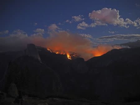 The Meadow Fire burns near Half Dome in Yosemite National Park, California, in this handout photo released to Reuters on September 8, 2014. REUTERS/Jeffrey Trust/National Park Service/Handout via Reuters