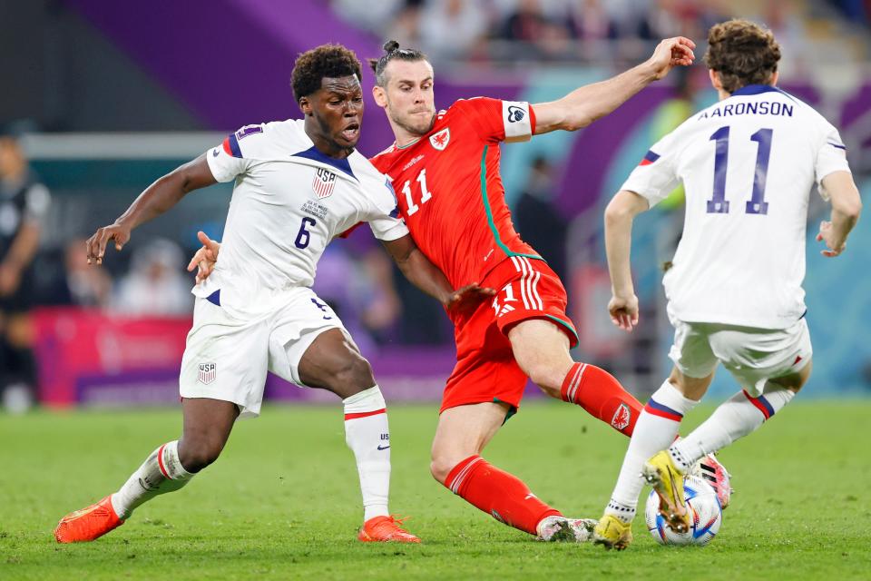 Gareth Bale fights for the ball with USMNT players.