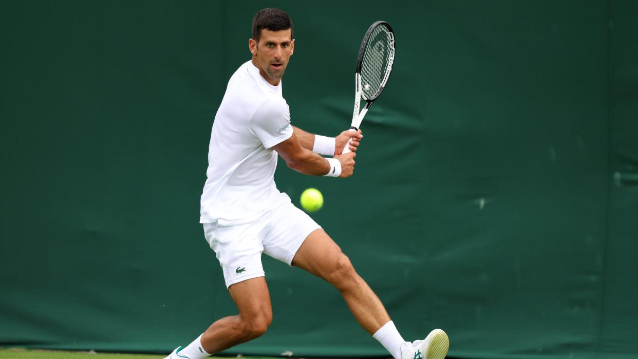  Novak Djokovic of Serbia plays a backhand during a practice session as Coach, Goran Ivanisevic, looks on ahead of The Championships - Wimbledon 2023 at All England Lawn Tennis and Croquet Club on June 28, 2023 in London, England. 