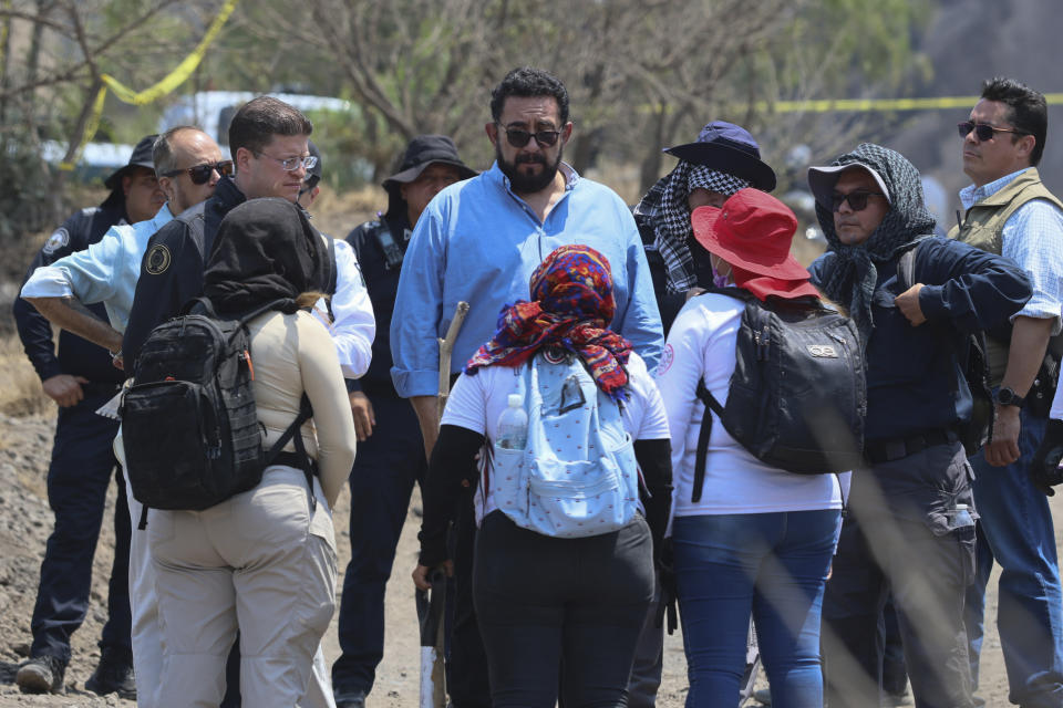 Mexico City interim Prosecutor Ulises Lara speaks with the mothers of missing children at the site where volunteer searchers said they found a clandestine crematorium in Tlahuac, on the edge of Mexico City, Wednesday, May 1, 2024. Ceci Flores, a leader of one of the groups of so-called "searching mothers" from northern Mexico, announced late Tuesday that her team had found bones around clandestine burial pits and ID cards, and prosecutors said they were investigating to determine the nature of the remains found. (AP Photo/Ginnette Riquelme)