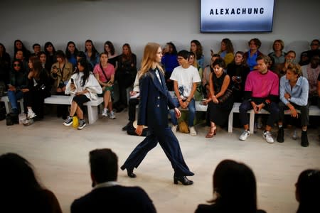 Members of the public watch models present creations at the Alexa Chung public catwalk show during London Fashion Week in London