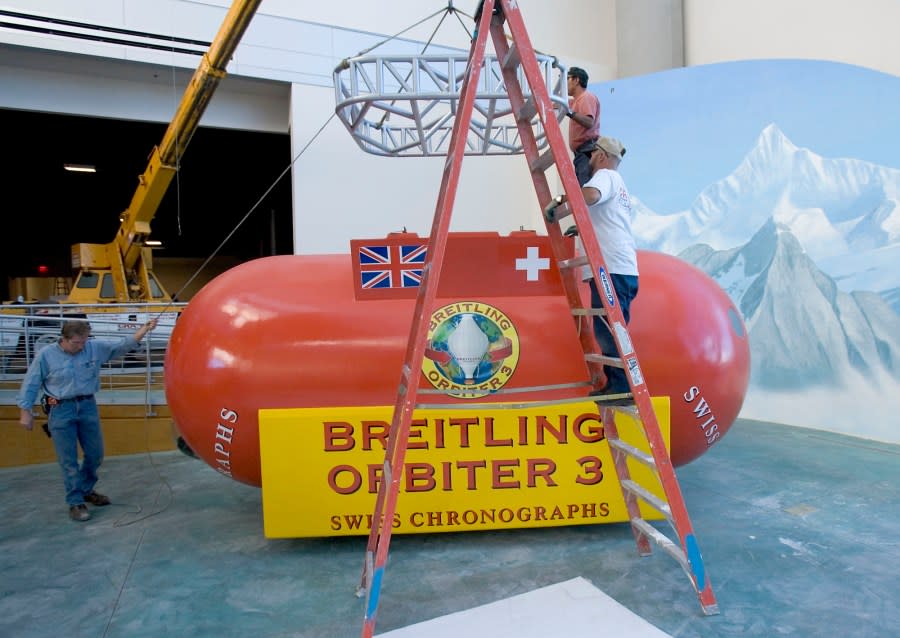 Workers lower a rack on to a replica of the Breitling Orbiter 3, the first manned balloon to circumnavigate the globe, at the Anderson-Abruzzo International Balloon Museum in Albuquerque, N.M., Wednesday, Sept. 14, 2005. The museum, scheduled to open Oct. 1, coinciding with the Albuquerque’s annual Balloon Fiesta, will have interactive computer exhibits, an expansive display of ballooning memorabilia and displays of record-setting balloons. (AP Photo/Jake Schoellkopf)