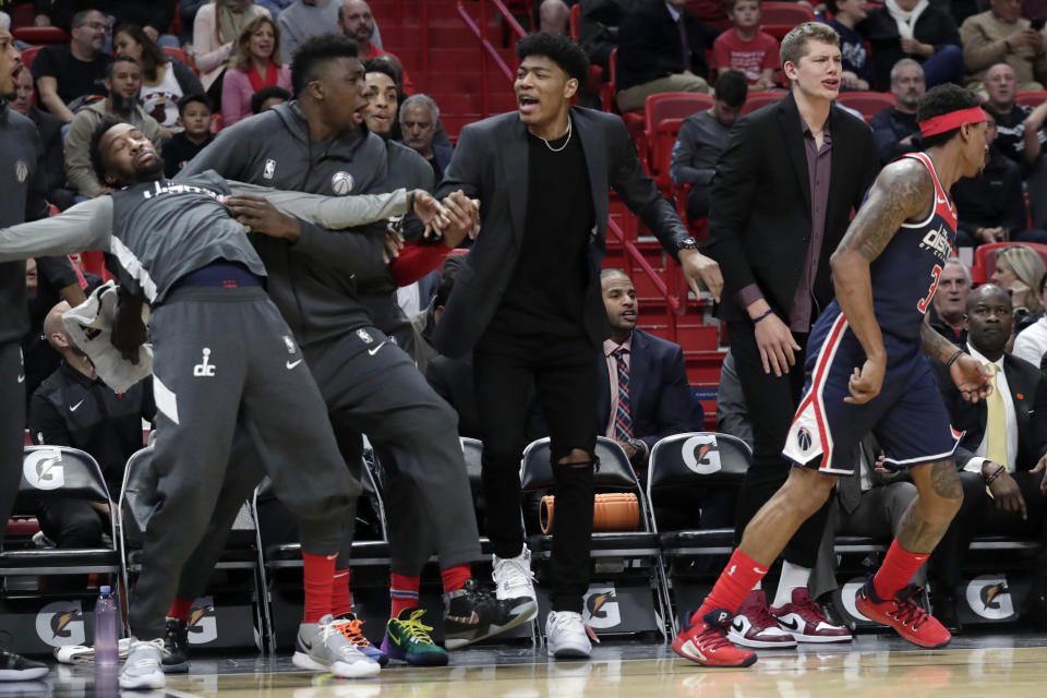 Washington Wizards forward Rui Hachimura, third from left, reacts with his teammates from the bench during the first half of an NBA basketball game against the Miami Heat, Wednesday, Jan. 22, 2020, in Miami. (AP Photo/Lynne Sladky)