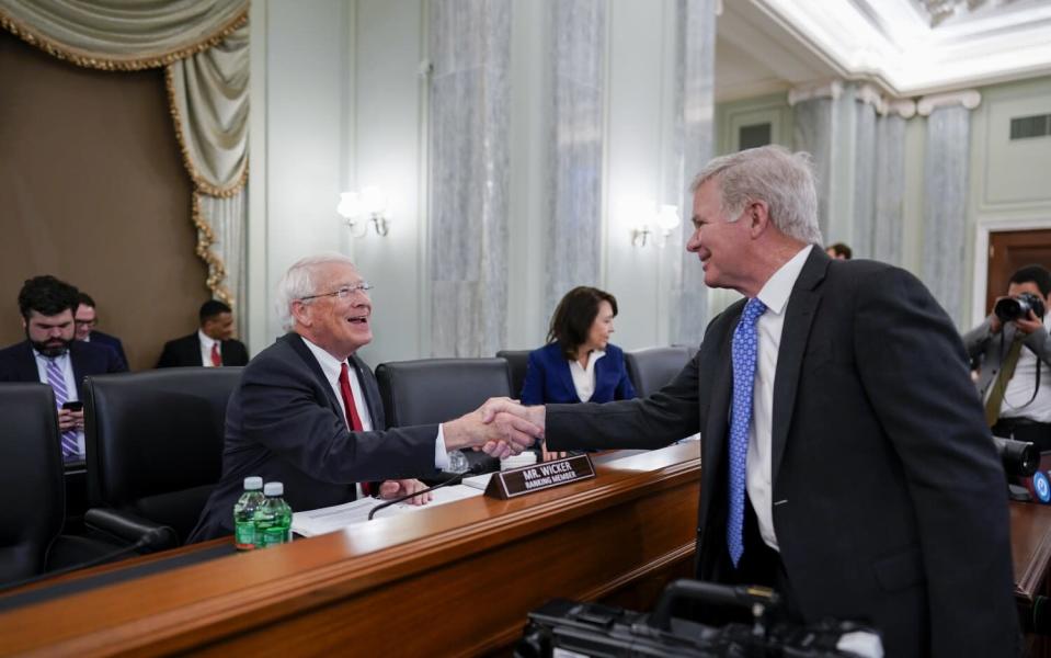 Sen.  Roger Wicker (R-Miss.), left, greets NCAA President Mark Emmert.