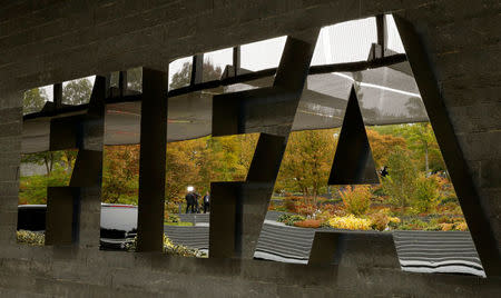 A TV team is reflected in a logo of FIFA a meeting of the FIFA Council at its headquarters in Zurich, Switzerland October 13, 2016. REUTERS/Arnd Wiegmann