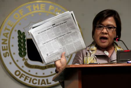 Former Justice Secretary and current Senator Leila De Lima shows reporters an article published on a local newspaper during a news conference at the Senate headquarters in Pasay city, metro Manila, Philippines September 22, 2016. REUTERS/Romeo Ranoco