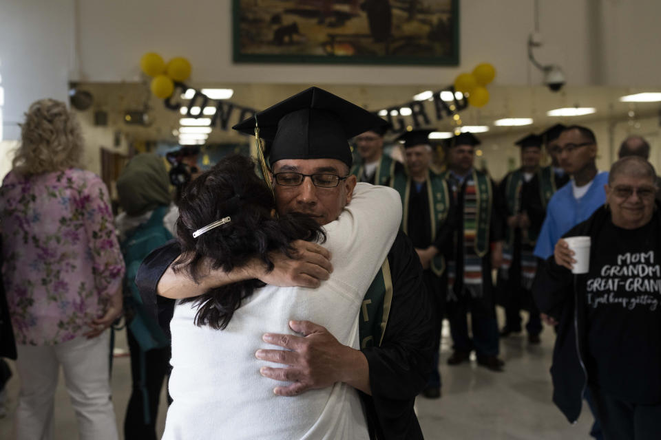 Incarcerated graduate Jose Catalan is hugged by his mother, Maria, before his graduation ceremony at Folsom State Prison in Folsom, Calif., Thursday, May 25, 2023. Catalan finished his bachelor's degree program in communications in prison. (AP Photo/Jae C. Hong)