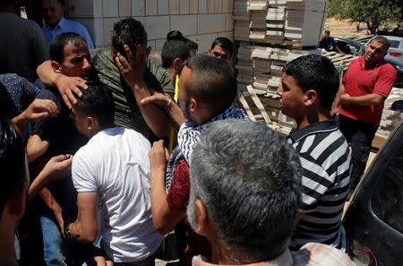 Relatives mourn during the funeral of Palestinian gunman Eyad Ghaith during his funeral in the West Bank city of Hebron June 29, 2017. REUTERS/Mussa Qawasma