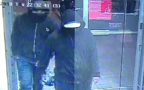 A CCTV image released by police shows two suspects walking in the Bombay Bhel restaurant before the bomb exploded. One is carrying an object - Credit: Peel Regional Police