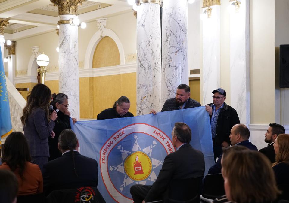 Members of the Standing Rock Sioux Tribal Government delegation present their tribal flag to hang in the South Dakota Capitol Rotunda on Wednesday, Jan. 10, 2024.