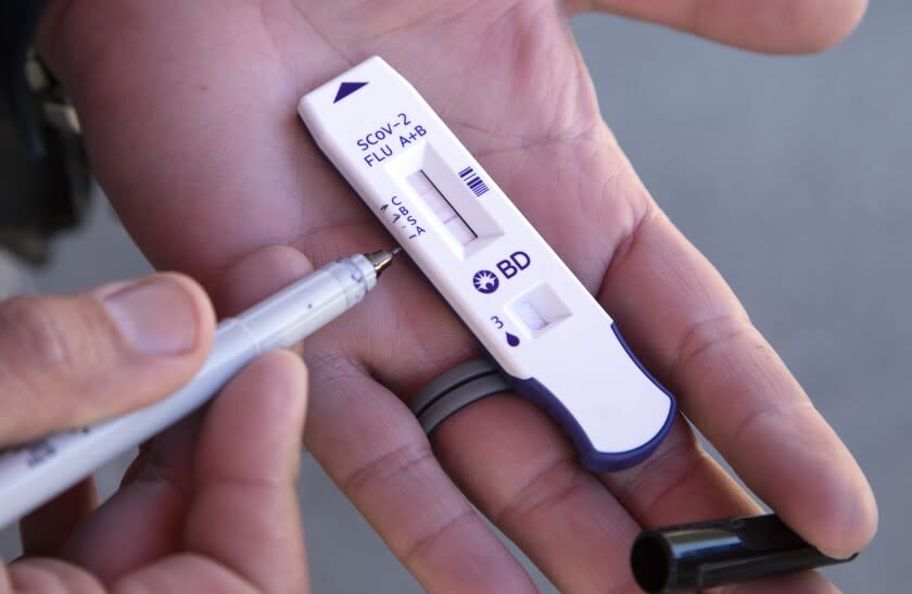 LOS ANGELES, CA - JANUARY 05: 911 COVID Testing's antigen test cassette shows the control at top followed by flu B, SARS-CoV-2 and flu A as shown on this demonstration sample by the company. Their site at 1300 N. Sepulveda Boulevard first identified a local case of "flurona" on Wednesday, Jan. 5, 2022. (Myung J. Chun / Los Angeles Times)